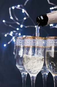 close-up-of-champagne-pouring-into-the-glass-at-night_23-2148253211.jpg