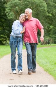 stock_photo_active_and_happy_senior_couple_walking_in_the_park_111401387.jpg